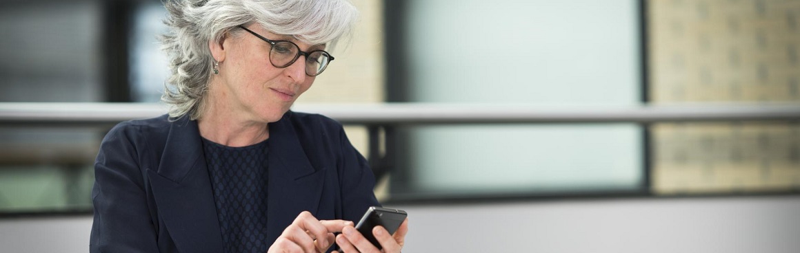 vrouw kijkt op haar mobiel